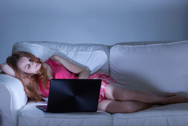 Woman using facebook instead of sleeping, horizontal